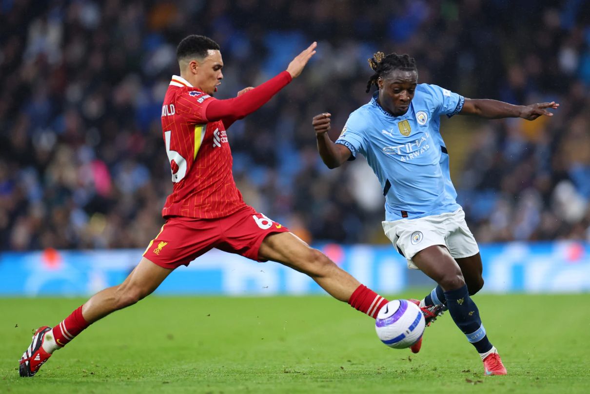 Alexander-Arnold tries to tackle Jeremy Doku.