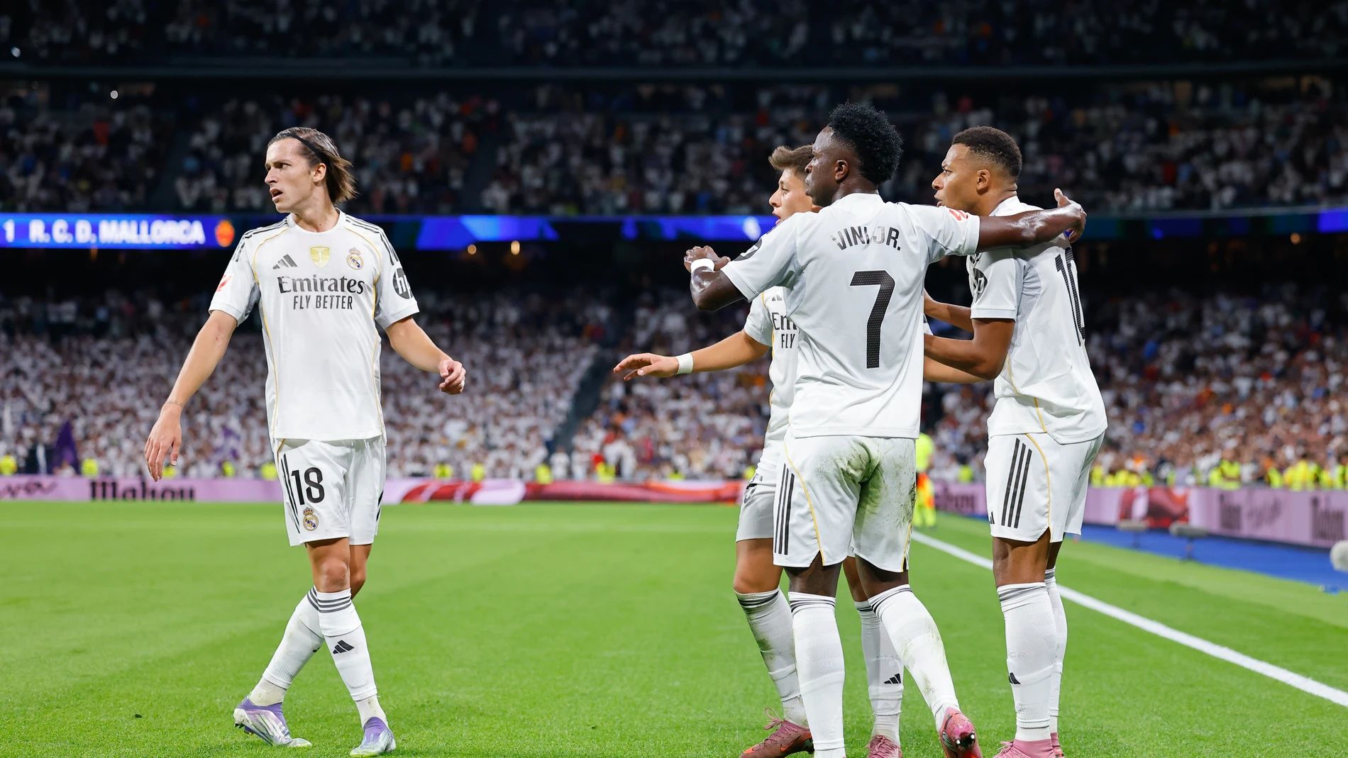 Vinicius Junior celebrates with Kylian Mbappe.